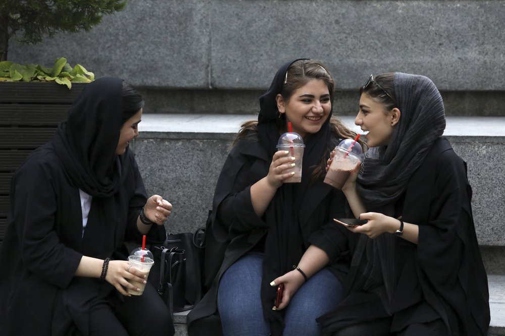 Some Iranian women take off hijabs as hard-liners push back